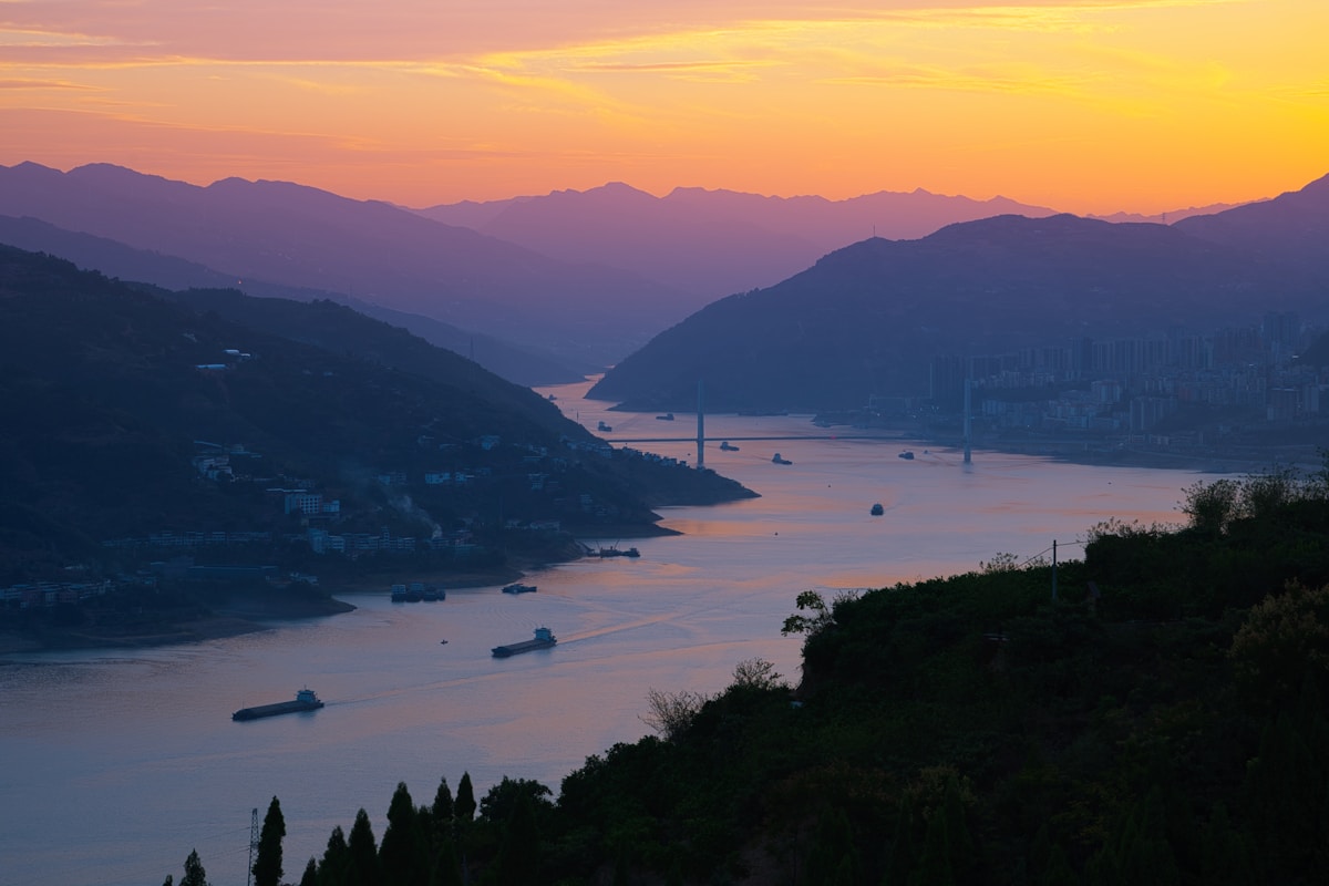 Chongqing: Complete Insider'S Guide To China'S 8D Magic City 13 A Sunset View Of A Body Of Water With Mountains In The Background
