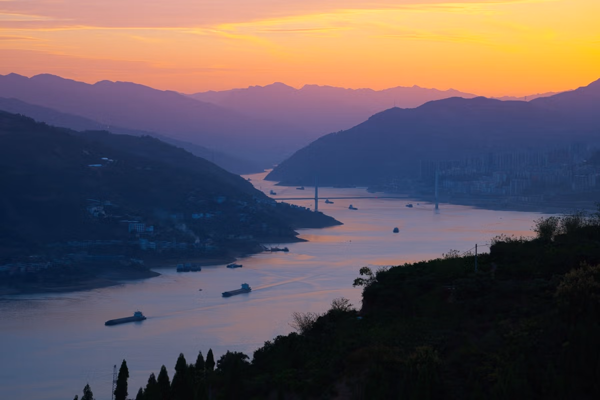 Chongqing: Complete Insider'S Guide To China'S 8D Magic City 13 A Sunset View Of A Body Of Water With Mountains In The Background