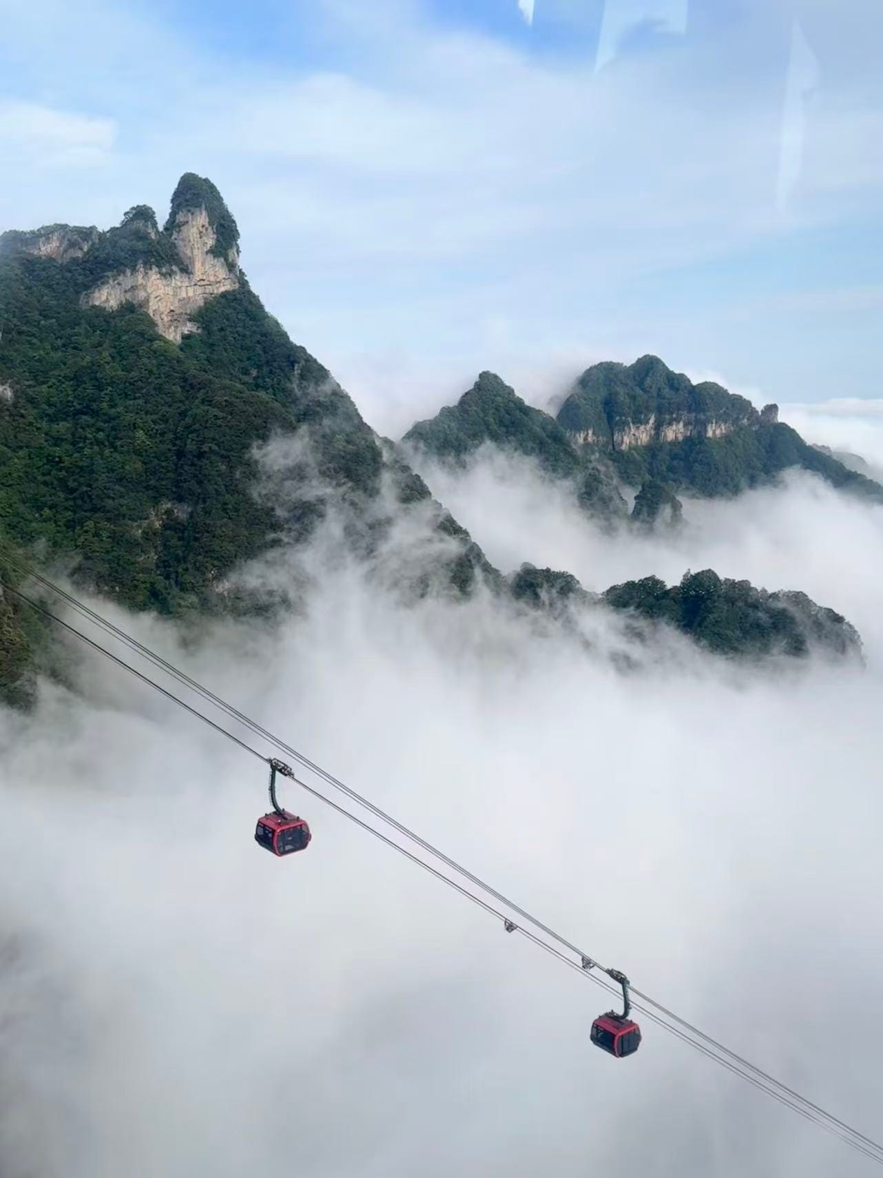 Cable Cars Above Misty Mountain Peaks