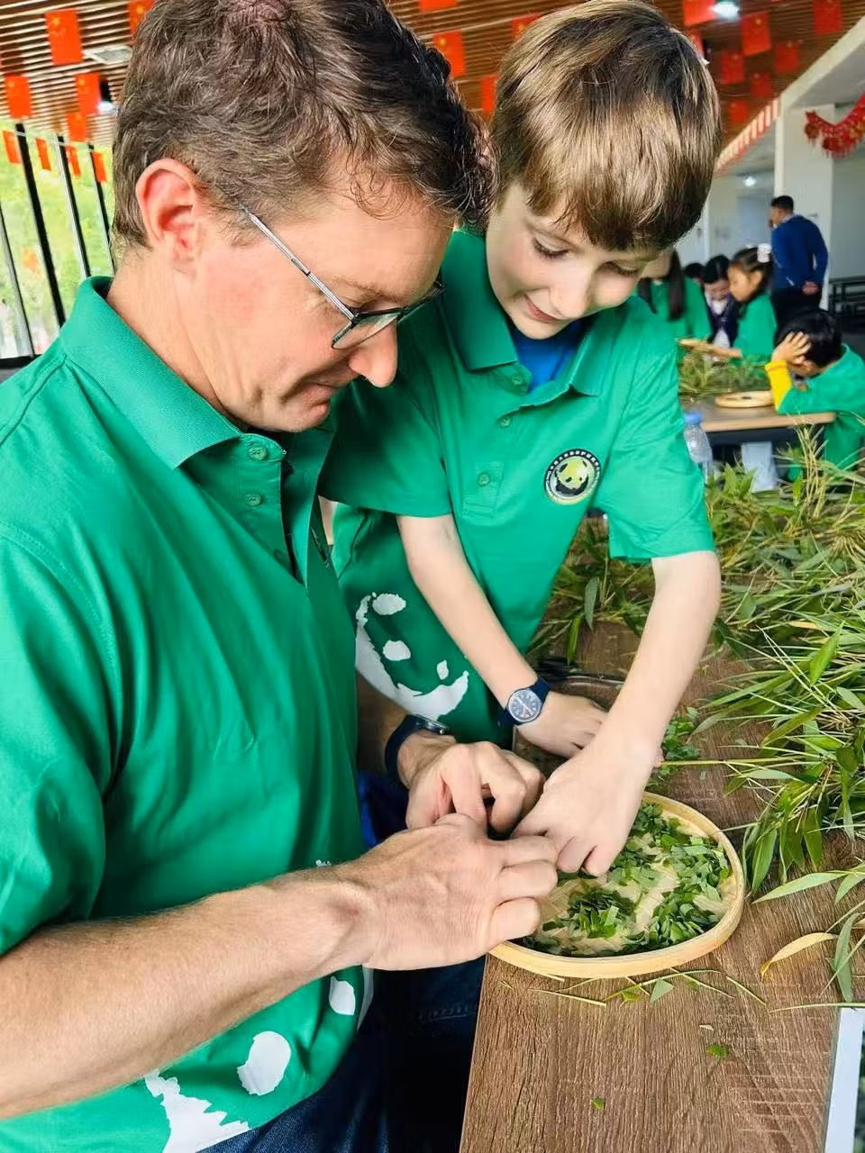 Chengdu Panda Bases Guide: Which One Should You Visit? 7 In June 2025, Our Guests From The Uk, Peter And His Son Casper, Participated In The Panda Volunteer Program At Wolong Panda Base. In The Photo, They Are Preparing Food For The Pandas.