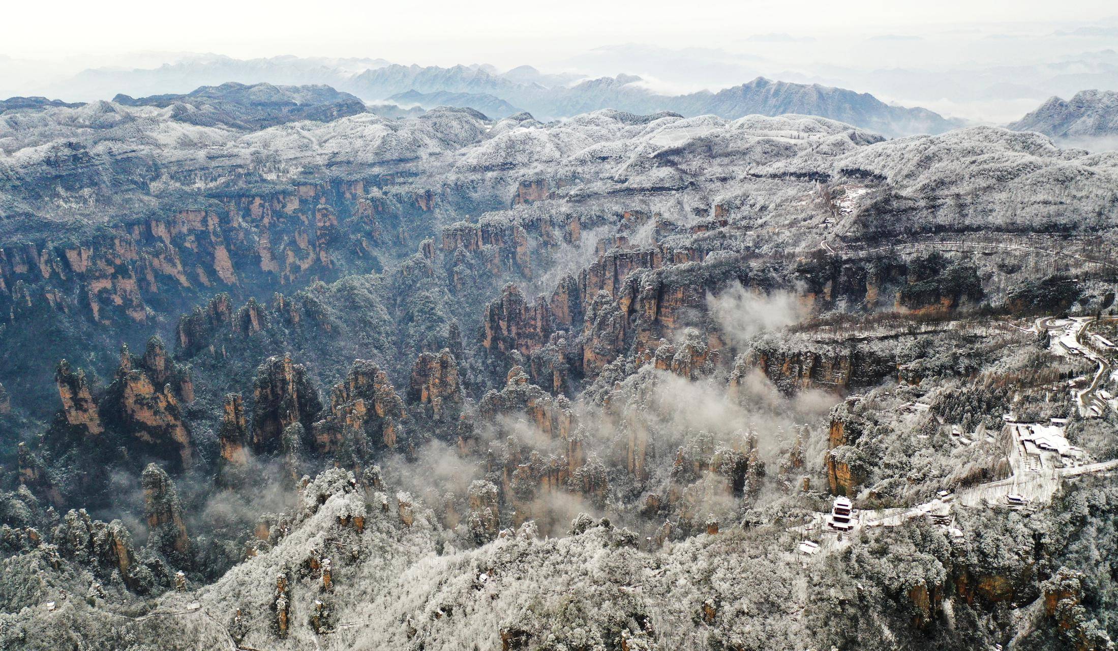 Snow-Covered Mountains With Misty Valleys
