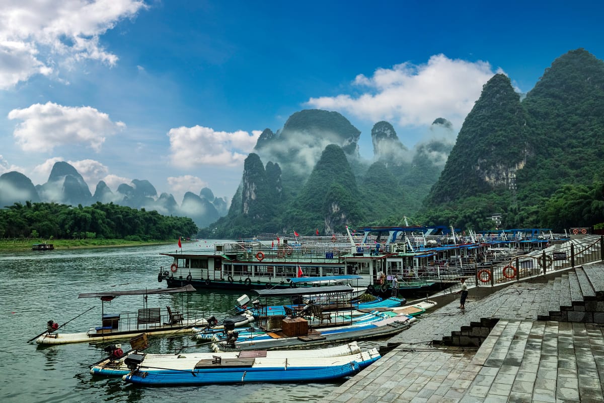 Xingping Fishing Village Cruise: Prices, Routes &Amp; Tips 2 The Wharf Features Bamboo Rafts And 3-Star Cruise Boats.