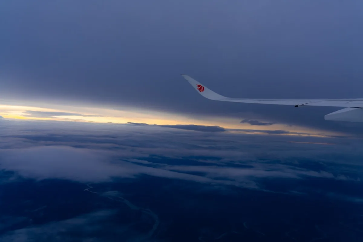 Air China Reviews: Our Unfiltered Take Before You Fly 11 Airplane Wing Over Clouds At Sunset