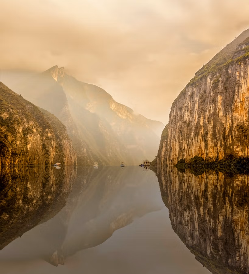 Exploring The Three Gorges: A Journey Through China’s Majestic Heart 12 Water Between Rocky Mountain Under White Cloudy Sky During Daytime Photo