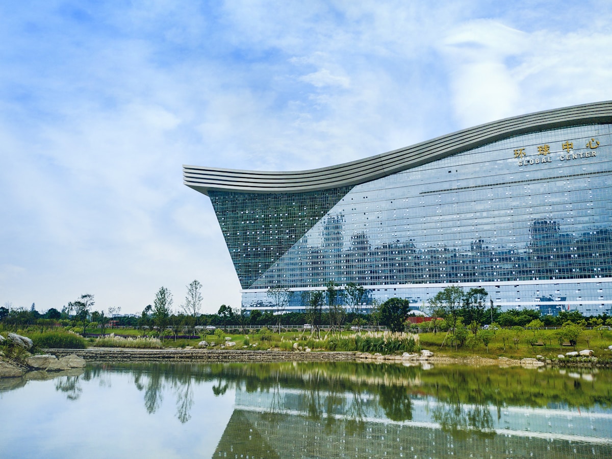 New Century Global Center Chengdu: An Epic Insider'S Guide 9 White Building Near Green Grass Field And Body Of Water During Daytime