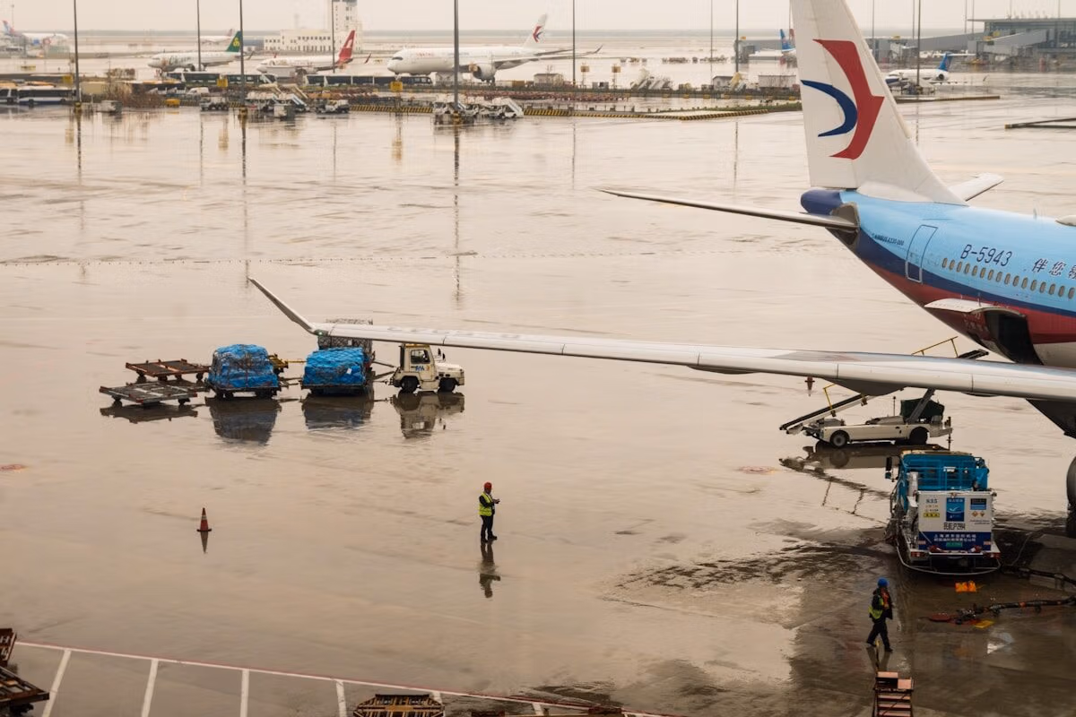 A Rainy Airport Is Flooded Near The Plane.