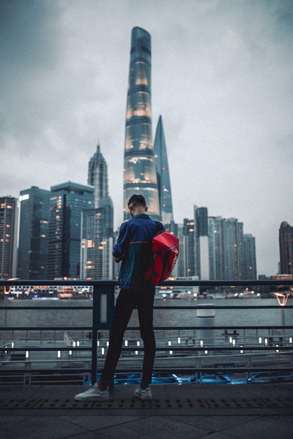 Shanghai Tower: The Ultimate Guide To The Tallest Building In China 11 Man In Red Hoodie And Black Pants Standing On Black Metal Railings