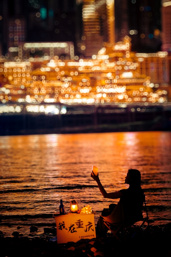 Hongya Cave: Ultimate Guide To Chongqing'S Real-Life Spirited Away 12 A Person Sitting On The Shore Of A Body Of Water